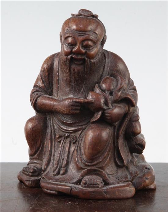 A Chinese bamboo seated figure of an immortal, 13.5cm